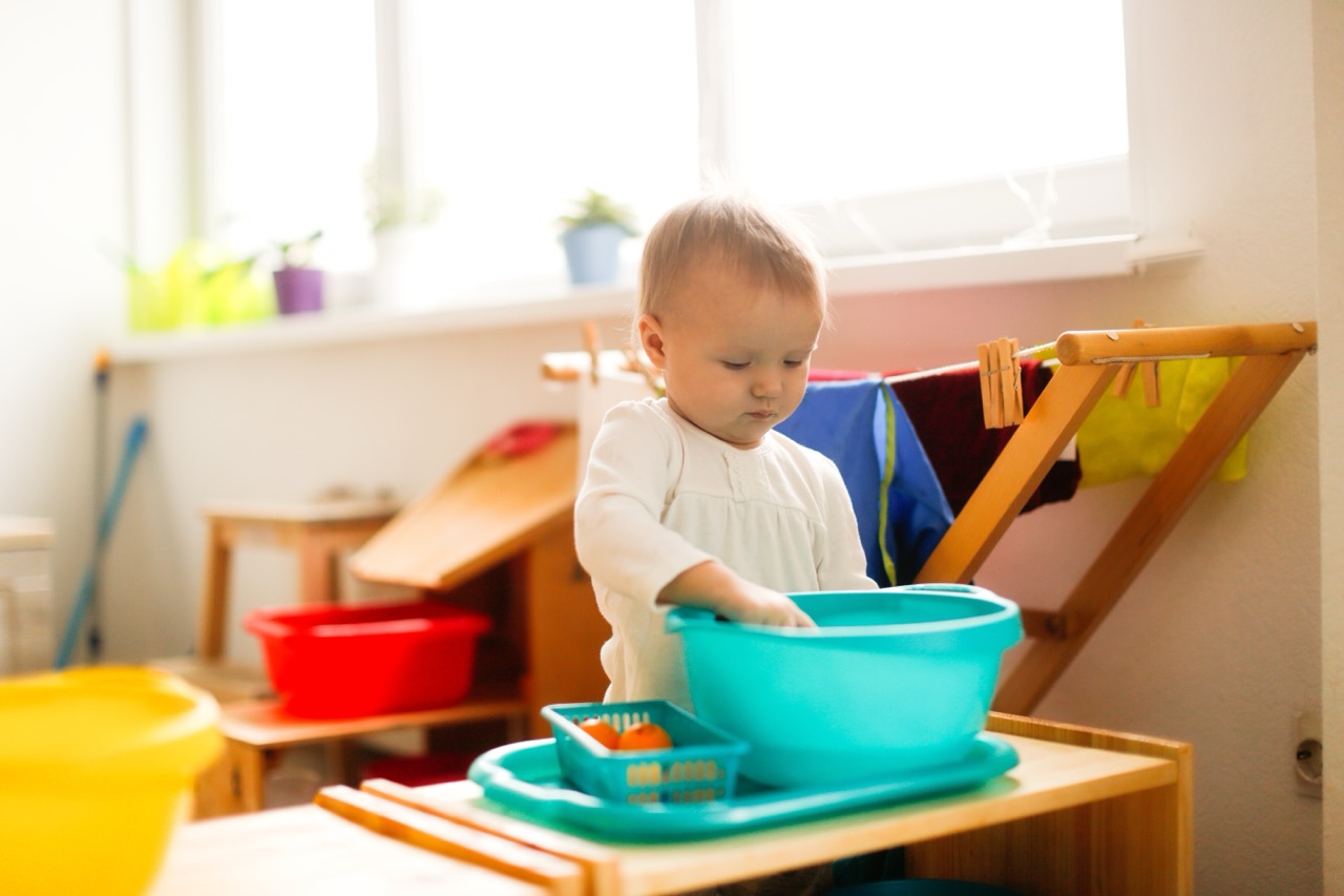 Young child engaged in a water activity at nursery